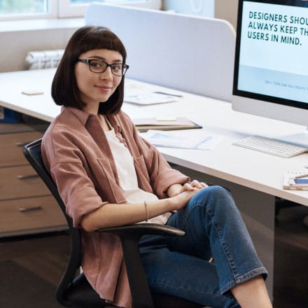 Woman Sitting on Chair at a Desk Woman Sitting on Chair at a Desk